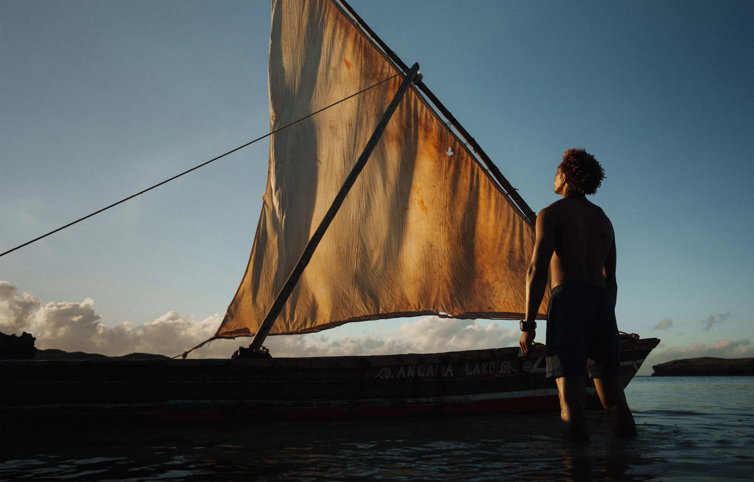 Sailor looking up at boat